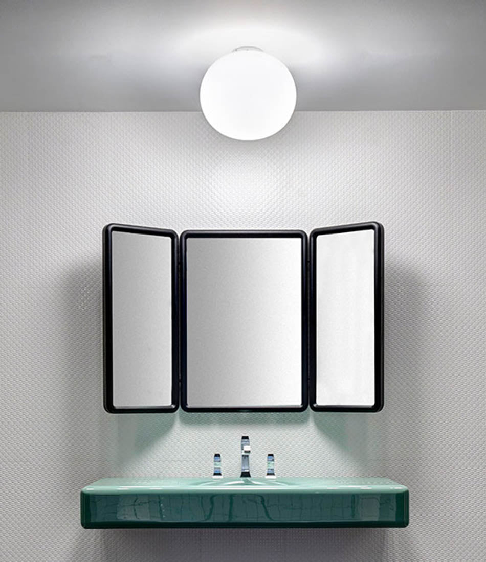 Flos Glo-Ball Ceiling sconce mounted above a bathroom vanity.