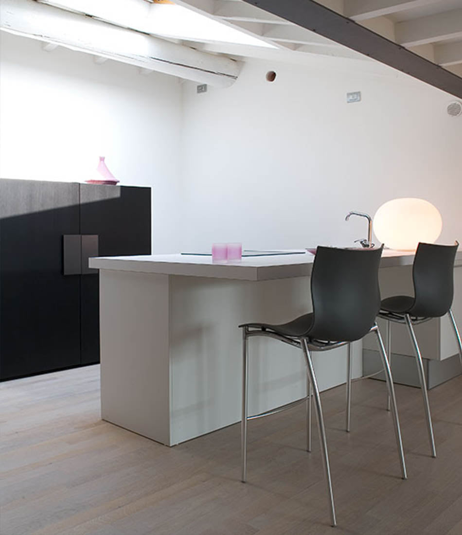 Large Flos Glo-Ball Basic table lamp on a bar counter.