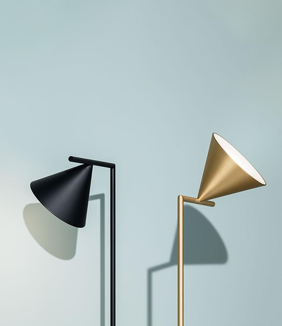 Two Flos Captain Flint floorlamp shades tilted in opposite directions.