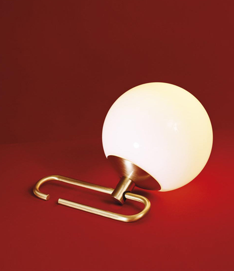 Artemide NH table lamp laying at an angle.