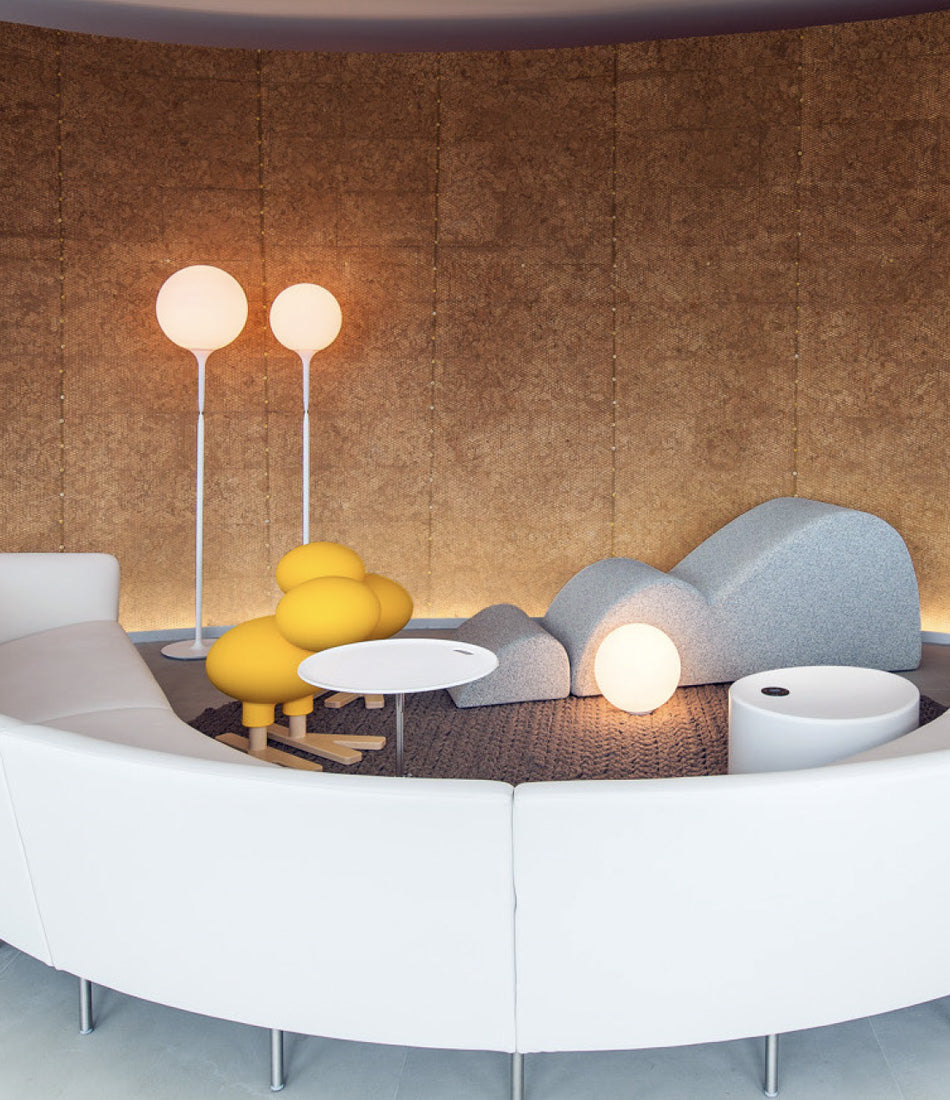 A furnished sitting room with Artemide Castore floor lamps.