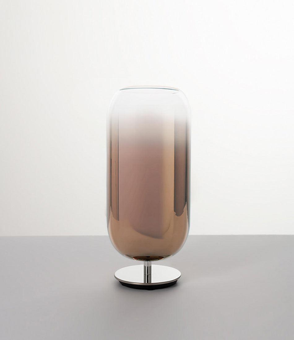 Pill-shaped Artemide Gople table lamp with steel chrome base and blown glass shade in gradient bronze.