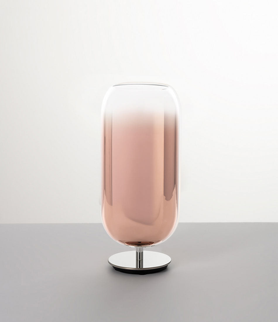 Pill-shaped Artemide Gople table lamp with steel chrome base and blown glass shade in gradient copper.