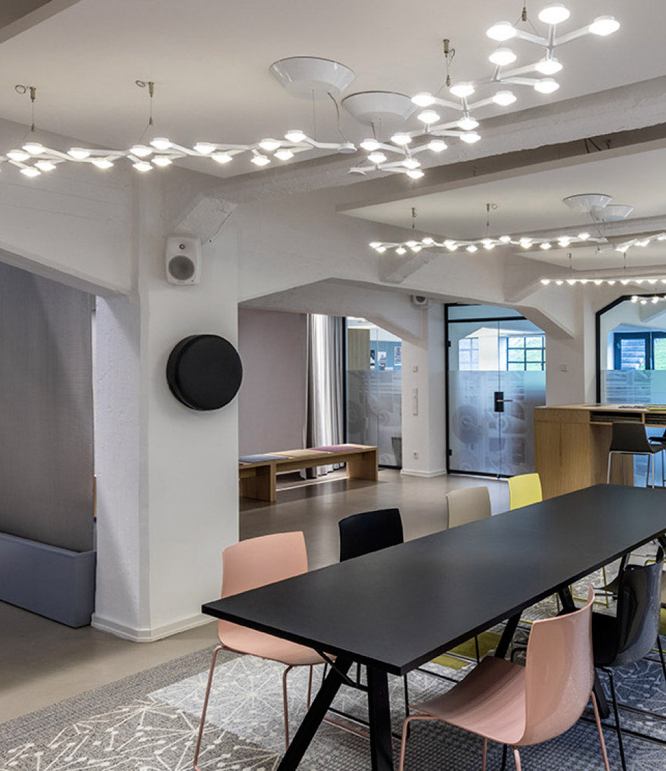 A series of Artemide Led Net Line 125 suspension lamps installed throughout a home's living area.