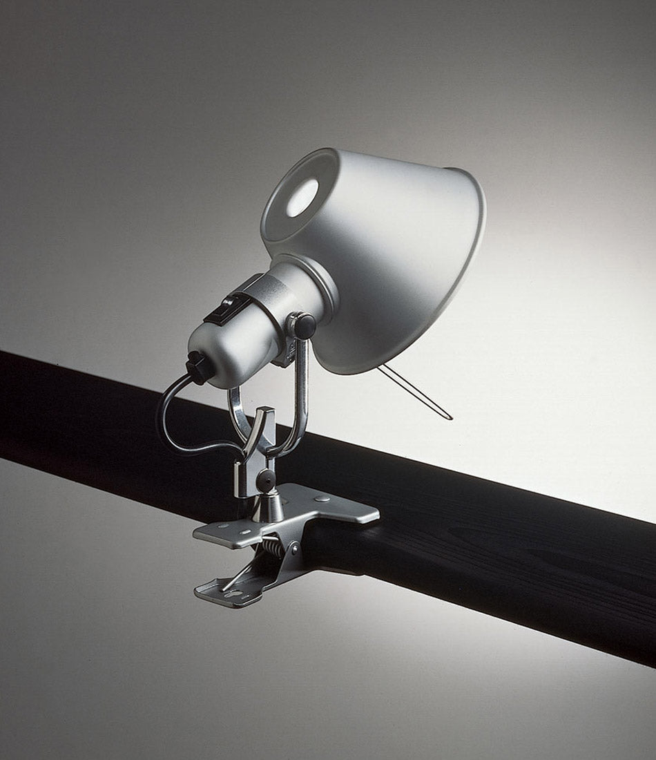 Artemide Tolomeo Clip Spot light clamped to a horizontal bar.