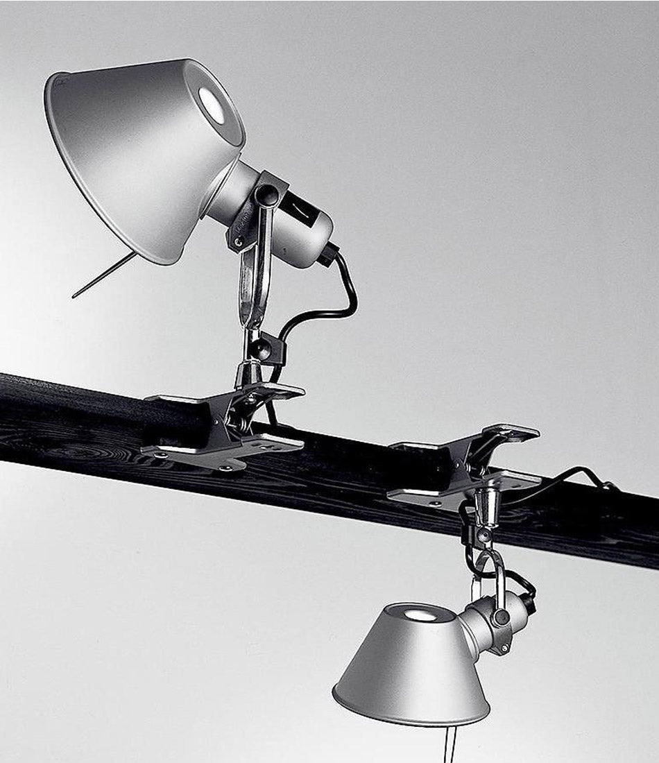 Two Artemide Tolomeo Clip Spot lights clamped to a bar, one above and the other below.