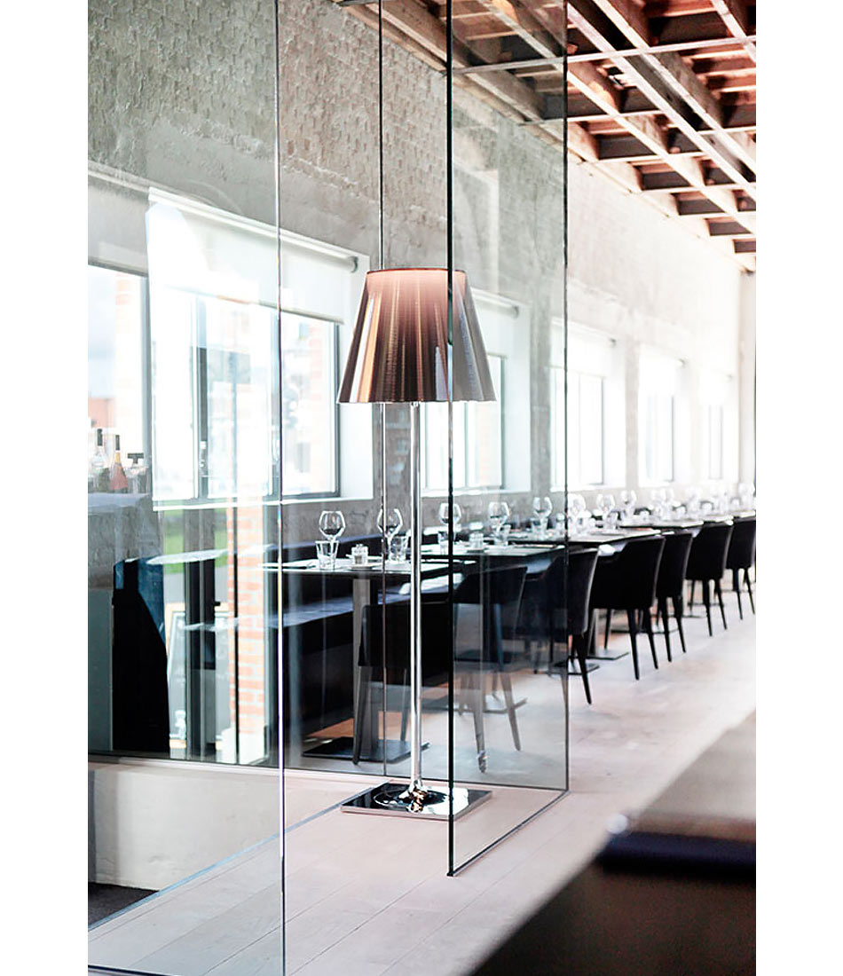 Flos KTribe floor lamp in aluminized bronze finish in a restaurant.