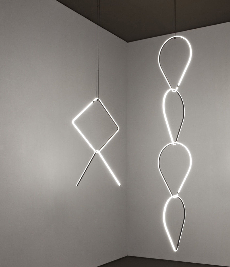 Flos Arrangements Pendant Light 3 and 4 hanging from a ceiling side by side.