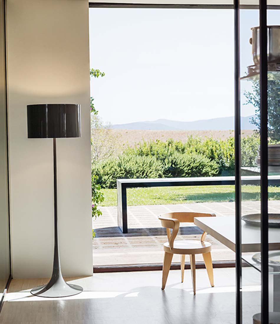 Flos Spun floor lamp beside an open door to a back yard patio.