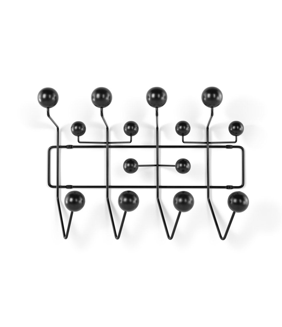 Wall mounted Herman Miller clothing hangar system with black frame and black ball hooks.
