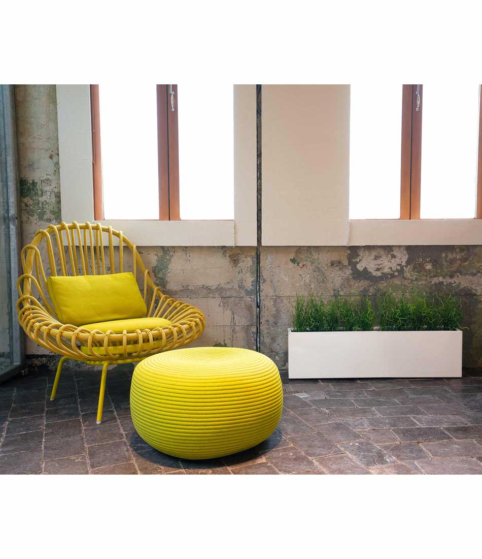 Layer planter in white gloss finish, next to a chair and ottoman.