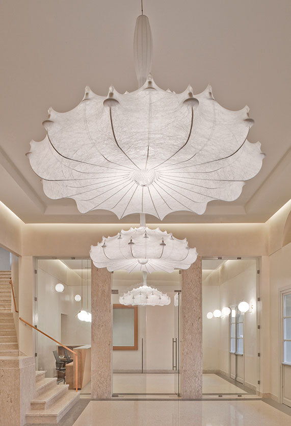 Three Flos Zeppelin suspension lamps in a lobby.