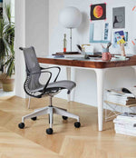 Setu Task Chair, Nelson Ball Lotus Table Lamp, Eames Wire-Base Coffee Table and Airia Desk.