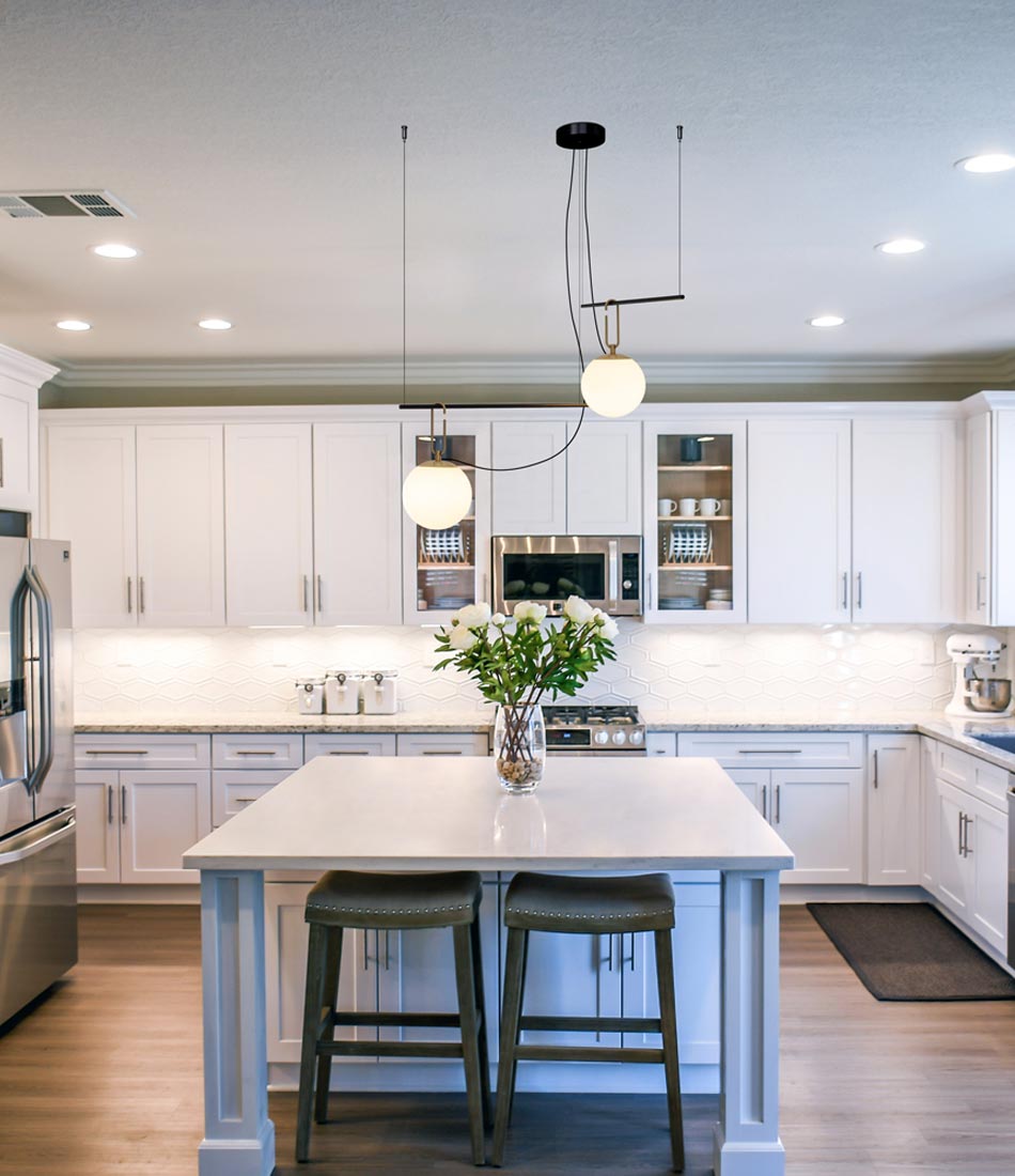 Artemide NH S3 2 Arm suspension lamp mounted above a kitchen island.
