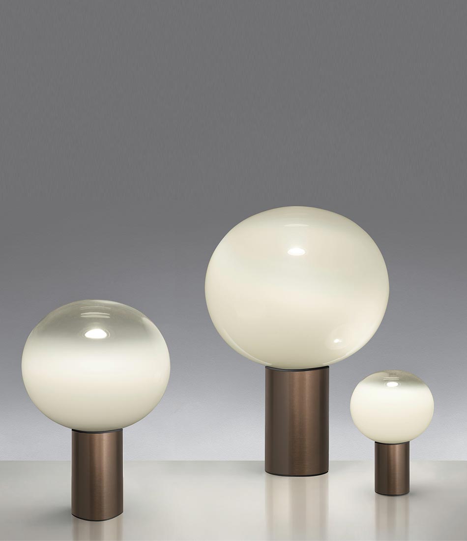 Three sizes of Artemide Laguna table lamps in satin bronze finish, grouped together.