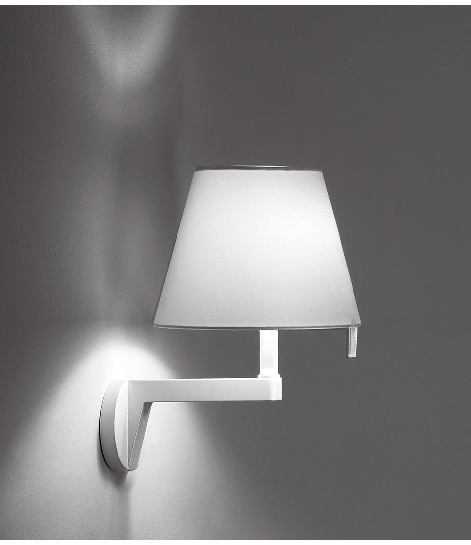 Artemide Melampo Mini wall lamp mounted to wall, with shade in level position.