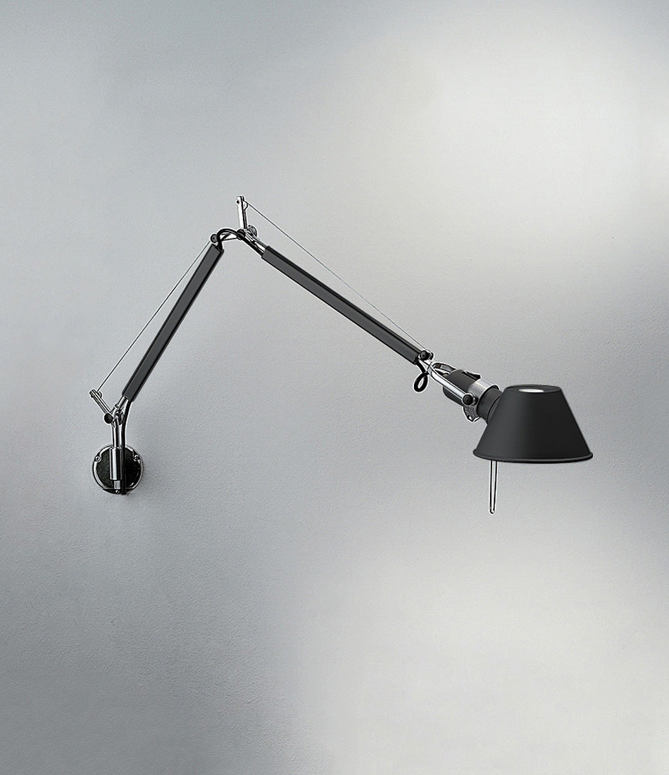 Black Artemide Tolomeo wall lamp mounted to a wall by a J-Bracket.