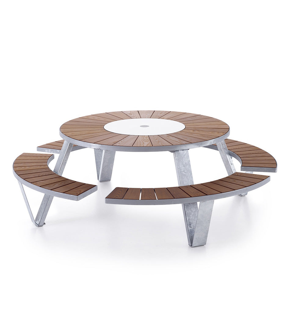 Galvanized steel Extremis Pantagruel picnic table, with dark hellwood slats on circular bench and circular tabletop.