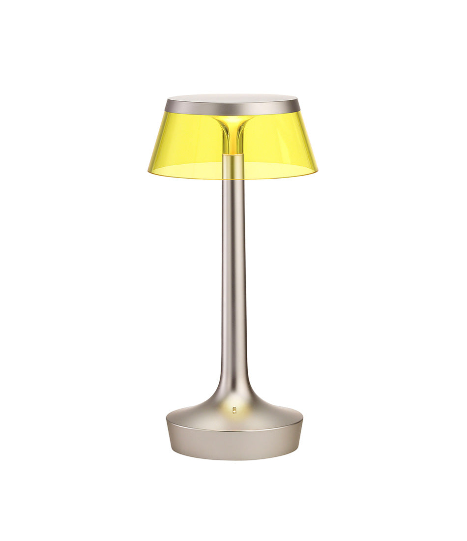 Flos Bon Jour Unplugged portable table lamp, with matte silver stem and yellow crown.